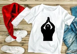 A person wearing a ski mask with hands raised above their head in a gesture