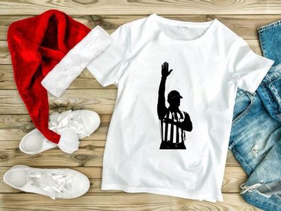 Referee in black and white silhouette signaling a call in a sports game