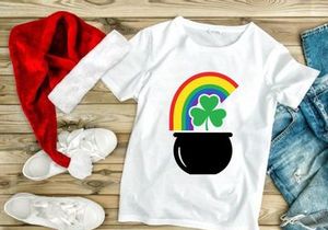 Lucky pot of gold with rainbow and shamrocks in black cauldron