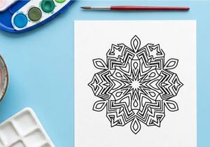 Hand-drawn black and white snowflake mandala with geometric Greek key pattern for Christmas decor
