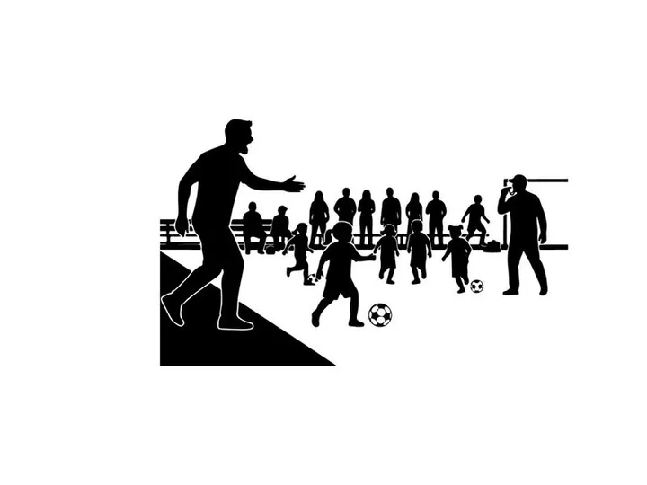 Silhouette of soccer players and spectators on a field