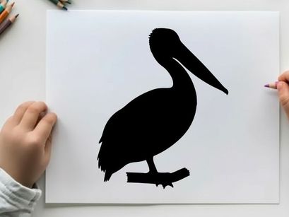 Silhouette of a pelican standing on a branch