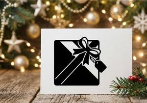 Black and white Christmas gift box with bow and tag for holiday celebration