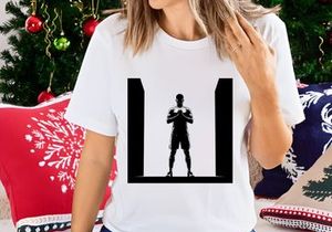 A silhouette of a man in a powerful stance with hands clasped together