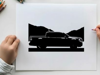 Silhouette of a pickup truck against a mountain range silhouette