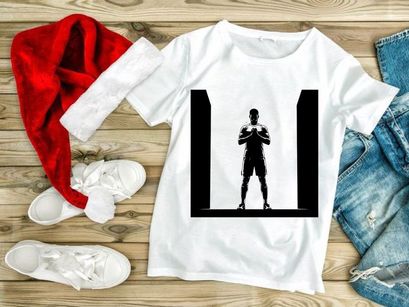 A silhouette of a man in a powerful stance with hands clasped together