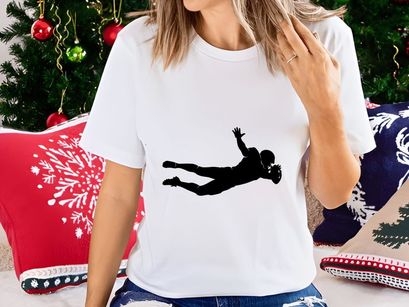 American football player diving to catch a ball in mid air