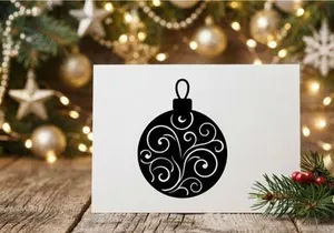 Black Christmas bauble silhouette with elegant swirl pattern for holiday design projects