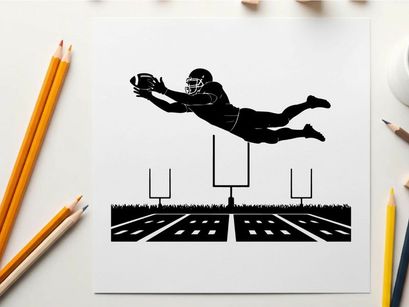 American football player in mid air silhouette catching a ball