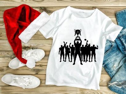 Victorious team celebrating with trophy in silhouette