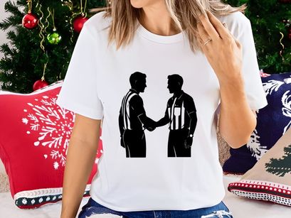 Two referees shaking hands in a gesture of sportsmanship and respect