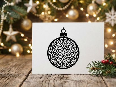 Decorative Christmas ornament with intricate black filigree design