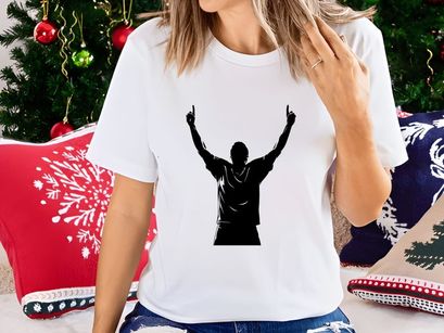 A man in a triumphant pose with arms raised high in the air