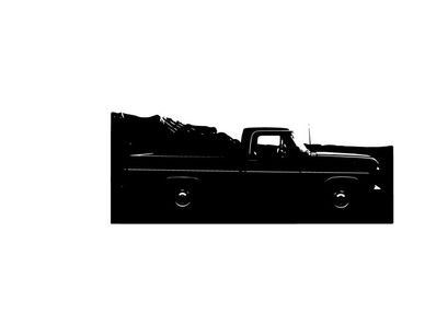 Silhouette of a classic pickup truck in front of a mountain range silhouette