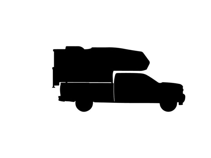 Silhouette of a delivery truck with cargo on top