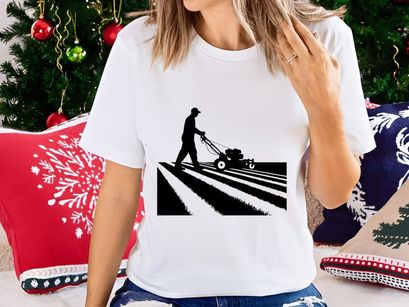 Man silhouette mowing lawn on sunny day with mower