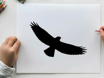 Silhouette of a bird in flight with outstretched wings preview picture