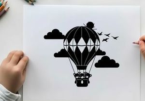Hot air balloon silhouette flying through sunny sky with clouds