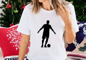 Silhouette of a soccer player kicking a ball in action