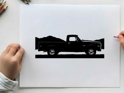 Silhouette of a pickup truck against a mountain range silhouette