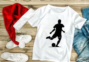 Soccer player kicking a ball in action silhouette