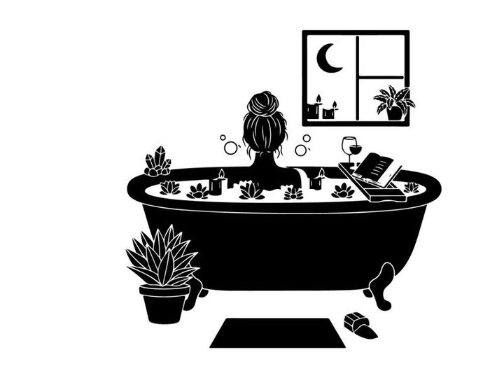 Silhouette of woman relaxing in a bubble bath at home