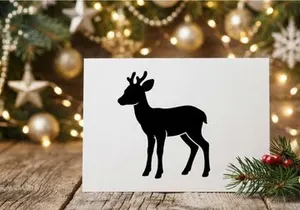 Black silhouette of a young deer with antlers isolated on a clean white background