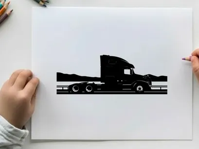 Silhouette of a semi truck driving on a highway with mountains