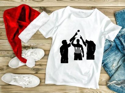 Silhouette of three men playing volleyball with referee