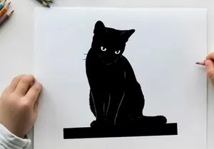 Black cat silhouette sitting on a platform looking forward