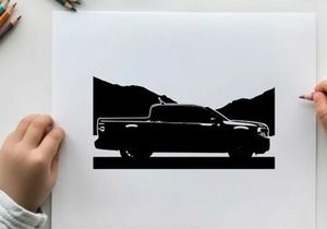 Silhouette of a pickup truck against a mountain range silhouette