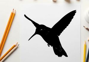 Silhouette of a hummingbird in flight with extended wings and beak