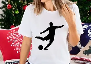 Silhouette of a soccer player kicking a ball in mid action