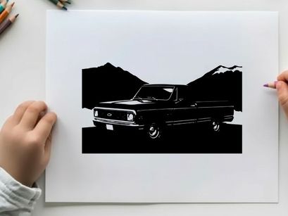 Silhouette of a classic pickup truck in front of mountains