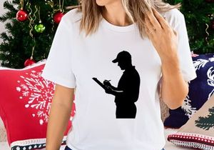 Silhouette of a man in a cap reading a document or writing