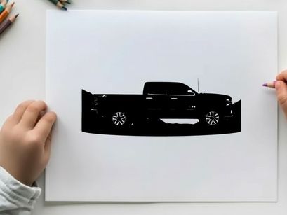 Silhouette of a pickup truck against a mountain range silhouette