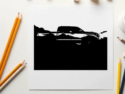 Silhouette of a pickup truck against a mountain range silhouette