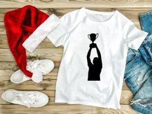 Silhouette of a champion holding trophy above head, celebrating victory