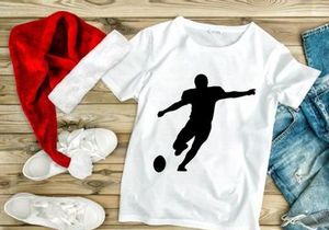 Silhouette of a soccer player kicking a ball in mid air motion