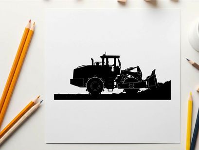 Silhouette of a large construction vehicle with a scoop