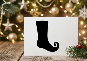 Black silhouette of a Christmas elf shoe or curly toe boot isolated on white background