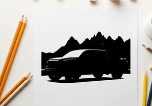 Silhouette of a pickup truck in front of mountains