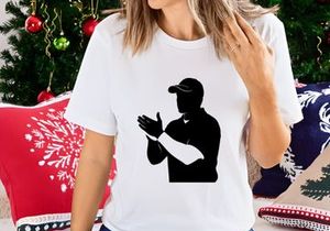 Silhouette of a man wearing a cap and clapping hands in a sports gesture