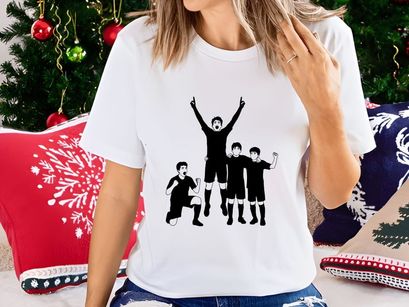 Four boys in black uniforms celebrating a sports achievement with joy and excitement