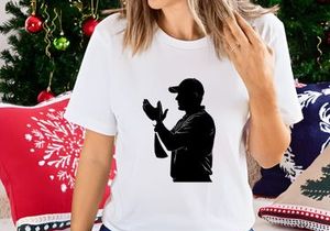 Silhouette of a man in a baseball cap gesturing with his hands