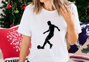 Silhouette of a soccer player kicking a ball in action