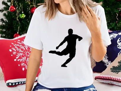 A silhouette of a person kicking an object with their right leg