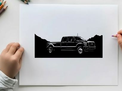 Silhouette of a pickup truck against a mountain range silhouette