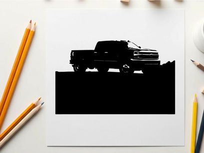 Silhouette of a pickup truck against a mountain range