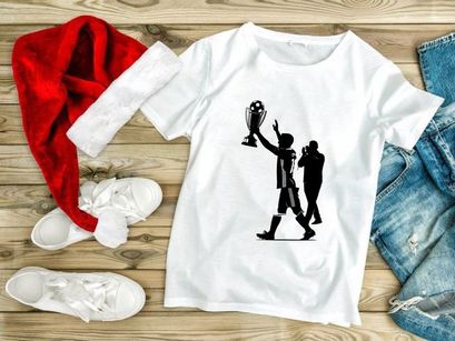 Victorious soccer player holding trophy with celebratory gesture and photographer